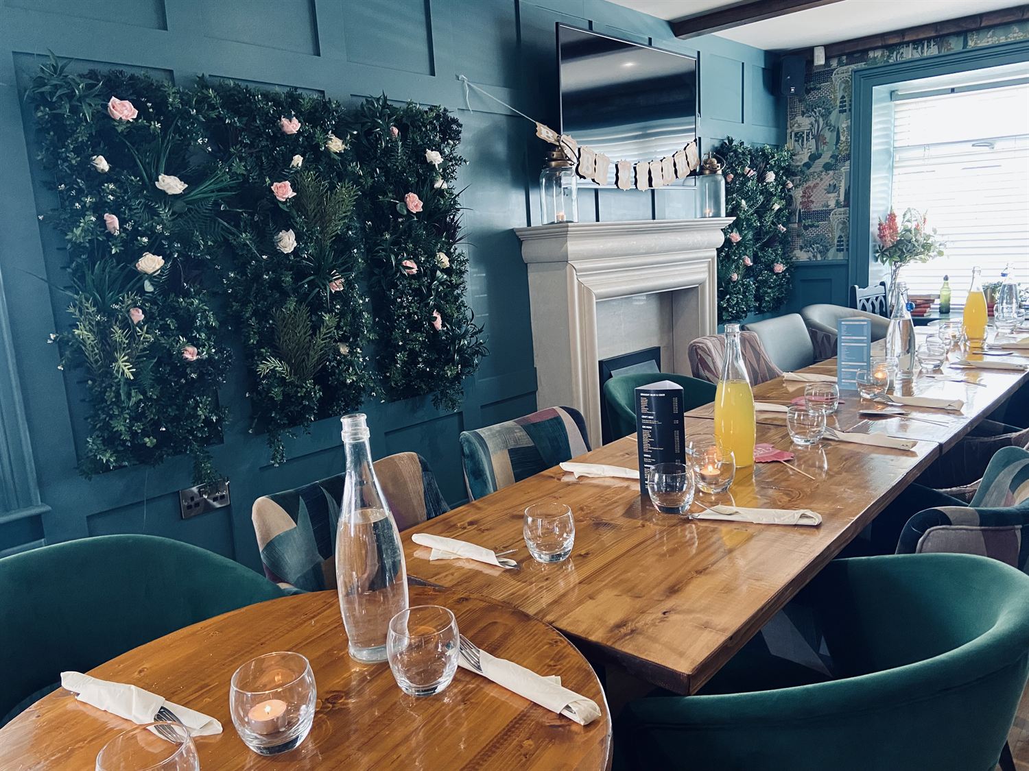 Private dining room styled with a floral wall for a celebration