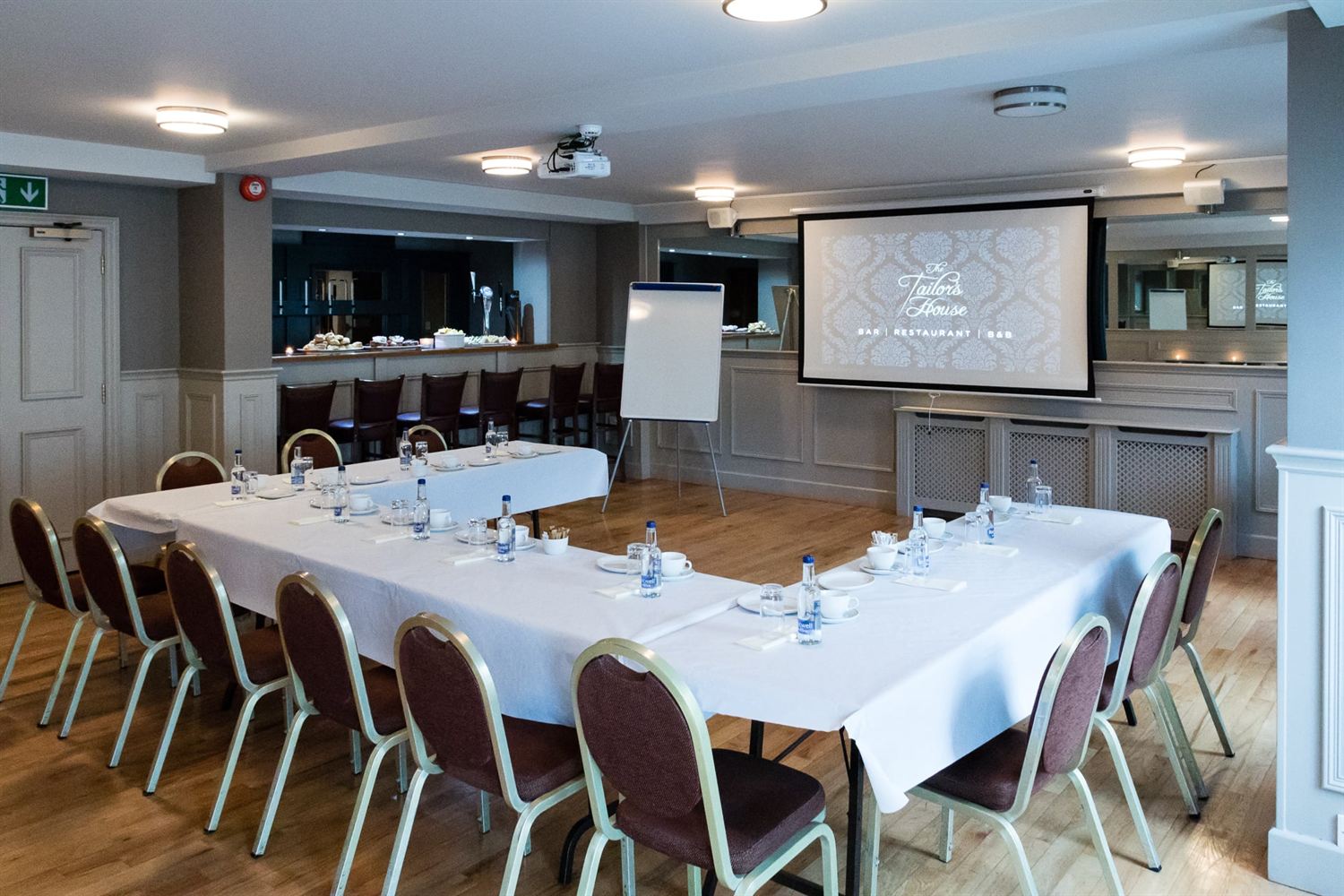 Function room set with banquet tables for a meeting or conference